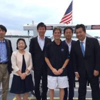 Director Al Steinman poses on an AWRI vessel with the delegation from Japan